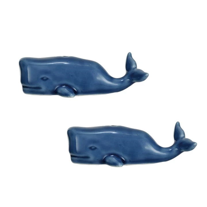 The Stoneware Whale Salt & Pepper Shakers are two smooth, minimalist blue whale figurines, both facing right and displayed vertically on a white background—ideal for nautical-themed kitchen decor.