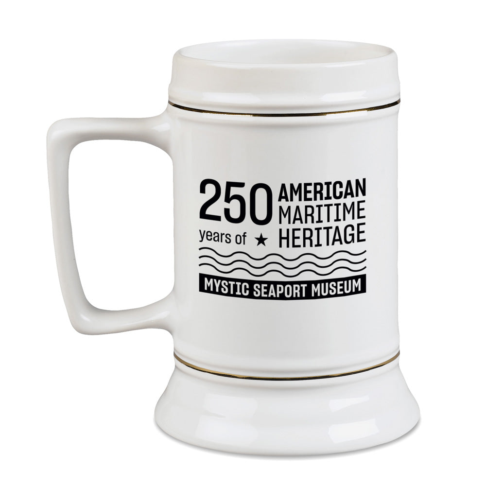 The Mystic Seaport Museum Connecticut Tall Ship Stein Mug is a white ceramic mug featuring black text, “250 years of American Maritime Heritage and Mystic Seaport Museum,” with star and wave designs—a perfect collectible for maritime history fans.