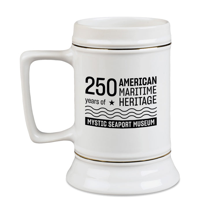 The Mystic Seaport Museum Connecticut Tall Ship Stein Mug is a white ceramic mug featuring black text, “250 years of American Maritime Heritage and Mystic Seaport Museum,” with star and wave designs—a perfect collectible for maritime history fans.