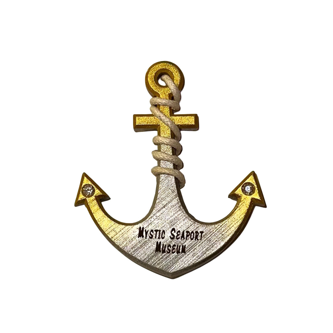 The Mystic Seaport Museum Anchor Magnet features wood construction, yellow edges, rope detail at the top, and "Mystic Seaport Museum" at the base. Two small gems accent the arrow tips—a charming maritime keepsake.
